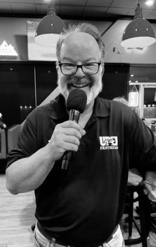 Kirk hosting with a microphone